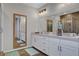 Bright bathroom with double vanity, framed mirror, modern lighting, and a glass-enclosed shower at 10161 Bismarck Palms Ave, Las Vegas, NV 89166