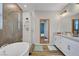 Relaxing bathroom with a soaking tub, glass-enclosed shower, and double vanity with modern fixtures at 10161 Bismarck Palms Ave, Las Vegas, NV 89166