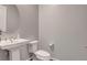 Elegant half-bathroom featuring a pedestal sink and fixtures at 10161 Bismarck Palms Ave, Las Vegas, NV 89166