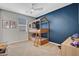 Charming bedroom with a bunk bed, blue accent wall, and ample space for play at 10161 Bismarck Palms Ave, Las Vegas, NV 89166