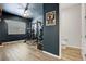 Home gym with workout equipment, ceiling fan, and tile floors at 10161 Bismarck Palms Ave, Las Vegas, NV 89166