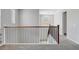Upstairs hallway with wood railing and soft carpet at 10161 Bismarck Palms Ave, Las Vegas, NV 89166