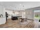 Bright, open kitchen with white cabinets, a dark island, and access to the backyard at 10161 Bismarck Palms Ave, Las Vegas, NV 89166