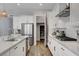 Bright kitchen features white cabinets, stainless steel appliances, a gas cooktop, and a subway tile backsplash at 10161 Bismarck Palms Ave, Las Vegas, NV 89166