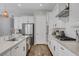 Bright kitchen with white cabinets, stainless steel appliances, a gas cooktop, and subway tile backsplash at 10161 Bismarck Palms Ave, Las Vegas, NV 89166