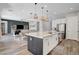 Open-concept kitchen with a large island, stainless steel appliances, and seamless flow into the living and dining areas at 10161 Bismarck Palms Ave, Las Vegas, NV 89166