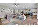 Open-concept living space featuring modern furnishings and wood-look floors at 10161 Bismarck Palms Ave, Las Vegas, NV 89166