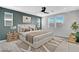 Stylishly staged main bedroom featuring a ceiling fan, two windows, and neutral tones at 10161 Bismarck Palms Ave, Las Vegas, NV 89166