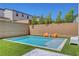 Stunning backyard features a sparkling pool, lush artificial grass, and tasteful outdoor seating perfect for relaxation at 10161 Bismarck Palms Ave, Las Vegas, NV 89166