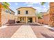 Spacious backyard featuring a covered patio and a low-maintenance desert landscape with palm trees at 11755 Garland Grove Ln, Las Vegas, NV 89183