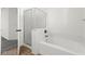 Bright bathroom featuring a soaking tub with tiled surround and glass shower door at 11755 Garland Grove Ln, Las Vegas, NV 89183