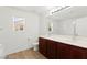 Modern bathroom featuring a double sink vanity, wood-style flooring, and ample counter space at 11755 Garland Grove Ln, Las Vegas, NV 89183