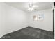Clean, gray carpeted bedroom with a ceiling fan and window at 11755 Garland Grove Ln, Las Vegas, NV 89183