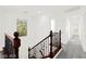 Bright hallway featuring a decorative railing overlooking the carpeted staircase below at 11755 Garland Grove Ln, Las Vegas, NV 89183