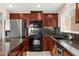Gourmet kitchen features stainless steel appliances, granite countertops, and custom cabinetry at 11755 Garland Grove Ln, Las Vegas, NV 89183