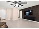 Bright living room featuring a flat screen television, ceiling fan, and a seamless open floorplan at 11755 Garland Grove Ln, Las Vegas, NV 89183