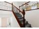 Staircase with carpeted steps and decorative wrought iron balusters for an elegant look at 11755 Garland Grove Ln, Las Vegas, NV 89183