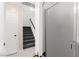 View of carpeted staircase with white interior door and a frosted glass closet door at 11755 Garland Grove Ln, Las Vegas, NV 89183