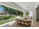 Stylish covered patio with plush seating and lush greenery, perfect for enjoying outdoor relaxation and views at 11775 Woodbrook Ct, Las Vegas, NV 89141