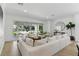 Bright living room with an open floor plan, white sofa, and view of the patio at 11775 Woodbrook Ct, Las Vegas, NV 89141
