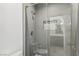 Contemporary shower featuring sleek tile work, glass enclosure, and modern fixtures with view of the bathroom at 11775 Woodbrook Ct, Las Vegas, NV 89141