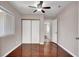 Cozy bedroom with wood floors, a ceiling fan, and closet with sliding doors at 118 Westin Ln, Henderson, NV 89002
