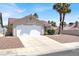 Single-story home featuring a two-car garage, desert landscaping, and mature palm trees at 118 Westin Ln, Henderson, NV 89002