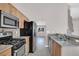 Well-equipped kitchen featuring stainless steel appliances, granite countertops, and wood cabinetry at 118 Westin Ln, Henderson, NV 89002