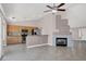 Open-concept living space featuring a fireplace, tile flooring, and a breakfast bar leading to the kitchen at 118 Westin Ln, Henderson, NV 89002