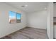 Bright living area featuring wood-look flooring and a large window at 1701 Desert Path Ave, North Las Vegas, NV 89032