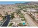 Expansive aerial view capturing the neighborhood and a home with a sparkling pool and manicured backyard at 1811 Country Meadows Dr, Henderson, NV 89012
