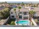 Aerial view of the pool, lawn, and rear exterior of the home amidst a residential neighborhood at 1811 Country Meadows Dr, Henderson, NV 89012