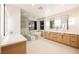 This stylish bathroom features a glass shower, a soaking tub, and a dual sink vanity at 1811 Country Meadows Dr, Henderson, NV 89012