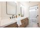 Modern bathroom with a double sink vanity, framed mirrors, and tile flooring at 1811 Country Meadows Dr, Henderson, NV 89012