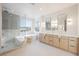 Elegant bathroom with a glass-enclosed shower, soaking tub by a window, and double vanity sinks at 1811 Country Meadows Dr, Henderson, NV 89012