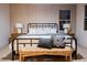 Cozy bedroom features a large bed with decorative pillows, neutral walls, and wood bedside tables at 1811 Country Meadows Dr, Henderson, NV 89012