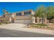 Charming two-story home featuring a well-manicured front yard, a driveway, and a three-car garage at 1811 Country Meadows Dr, Henderson, NV 89012