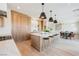Bright, modern kitchen with wooden cabinets, large island with seating, and stainless steel appliances at 1811 Country Meadows Dr, Henderson, NV 89012