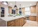 Modern kitchen with a large island, stainless steel appliances, and natural wood cabinets at 1811 Country Meadows Dr, Henderson, NV 89012