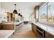 Modern kitchen with a large island, lots of natural light, and stainless steel appliances at 1811 Country Meadows Dr, Henderson, NV 89012