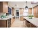Stylish kitchen with modern appliances, stone countertops, large island, and adjacent dining area at 1811 Country Meadows Dr, Henderson, NV 89012