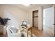 Small, bright office with an open closet, a desk, and a comfortable armchair at 1811 Country Meadows Dr, Henderson, NV 89012