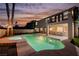 Twilight view of the backyard pool, patio, upper balcony, and rear exterior at 1811 Country Meadows Dr, Henderson, NV 89012