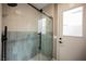 Modern glass shower with gray tile accents, a sleek black handle, and matte black rainfall showerhead at 1811 Country Meadows Dr, Henderson, NV 89012