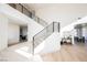 Modern staircase with black railings and open-concept design, bright and airy at 1811 Country Meadows Dr, Henderson, NV 89012