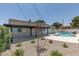 Private backyard with a refreshing in-ground pool, covered patio, and low-maintenance landscaping, ideal for outdoor activities at 1852 E Viking Rd, Las Vegas, NV 89169