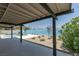 View of the covered backyard patio overlooking pool and mature landscaping at 1852 E Viking Rd, Las Vegas, NV 89169