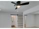 Sizable bedroom with a lighted ceiling fan, closet with sliding doors and ensuite bathroom at 1852 E Viking Rd, Las Vegas, NV 89169