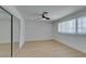 Bright bedroom features a ceiling fan, light wood floors, and closet with mirrored doors at 1852 E Viking Rd, Las Vegas, NV 89169