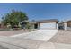 View of exterior showcasing front yard, driveway, and desert landscaping at 1852 E Viking Rd, Las Vegas, NV 89169